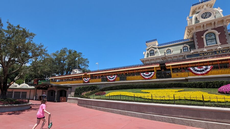 A girl walks through the entrance of Magic Kingdom in Florida