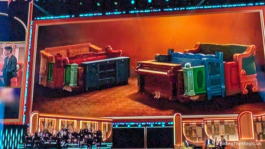 A colorful image of a sofa and piano on stage with a band in the background