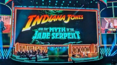 Indiana Jones and the Myth of the Jade Serpent logo on a stage with a band
