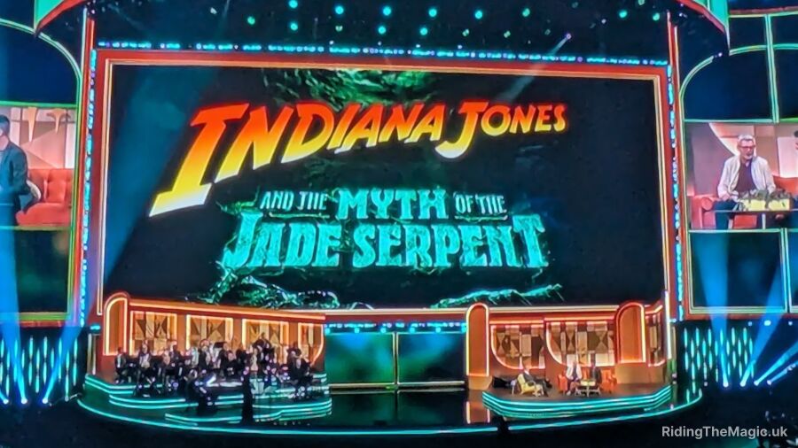 Indiana Jones and the Myth of the Jade Serpent logo on a stage with a band