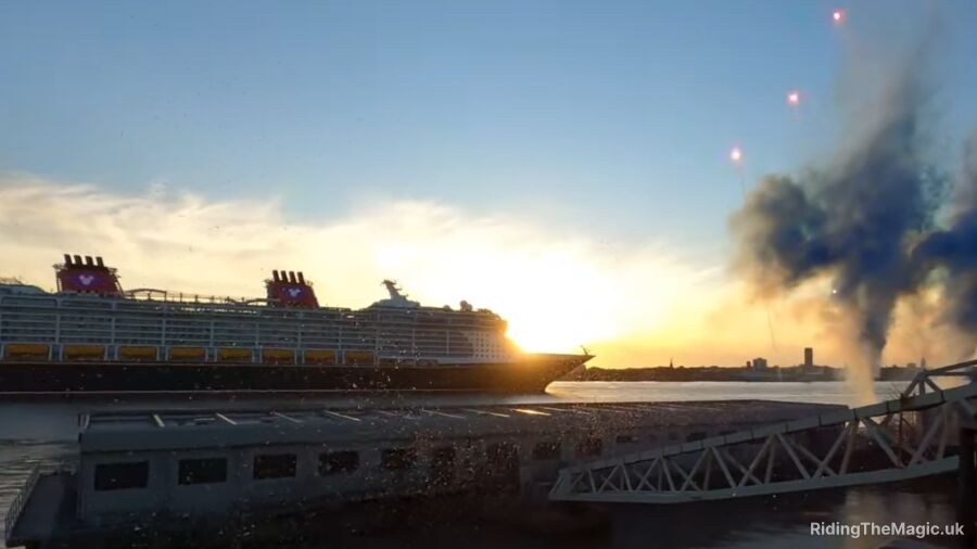 Disney Cruise Line's newest ship, the Disney Wish, sails into the harbor at dusk
