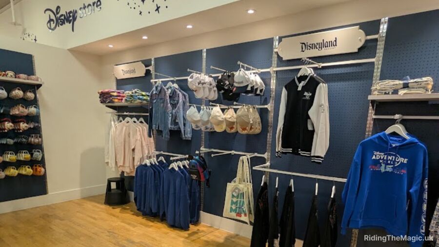 A Disney store with clothing, hats, and bags on display