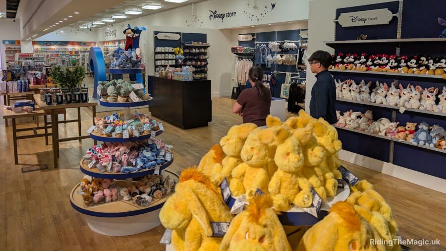 Disney store with a display of yellow stuffed animals