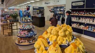 Disney store with a display of yellow stuffed animals