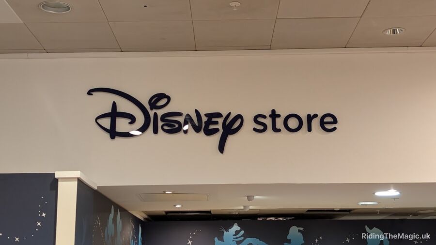 A sign for a Disney store on the wall of a building