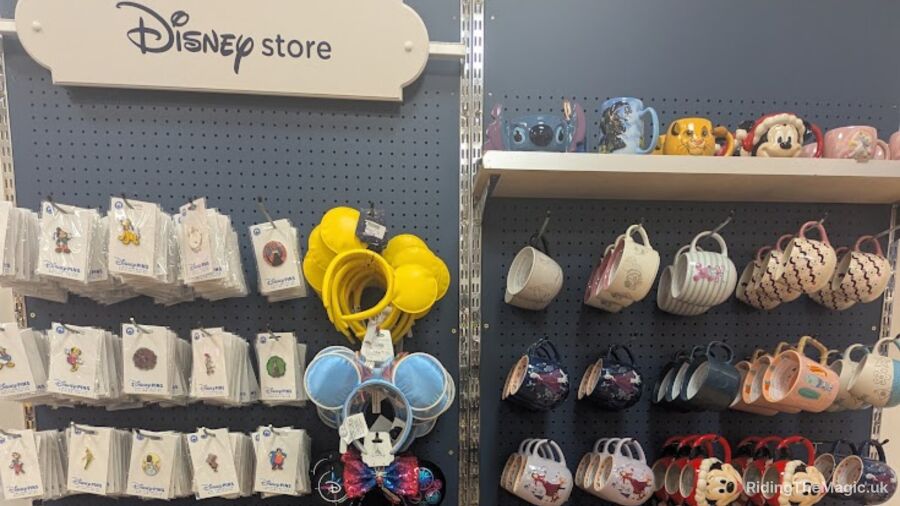 Disney store with Disney merchandise on display, including mugs, headbands, and pins