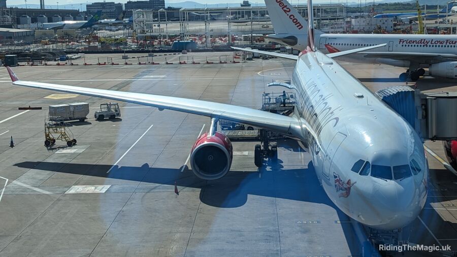 A large white airplane is parked on a runway at an airport