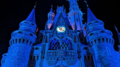 Cinderella Castle at Walt Disney World lit up in blue for the holidays