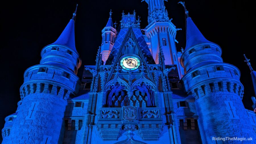 Cinderella Castle at Walt Disney World lit up in blue for the holidays