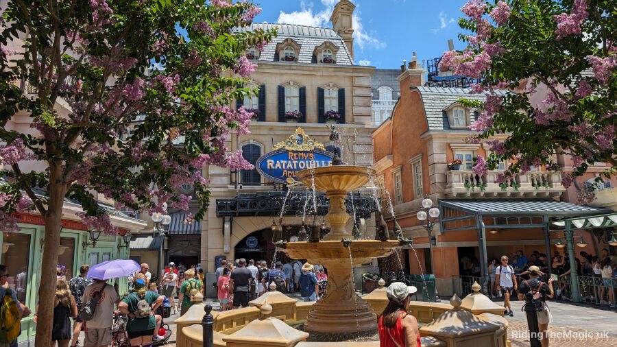 People gather around a fountain in front of Remy's Ratatouille Adventure at Disneyland Paris